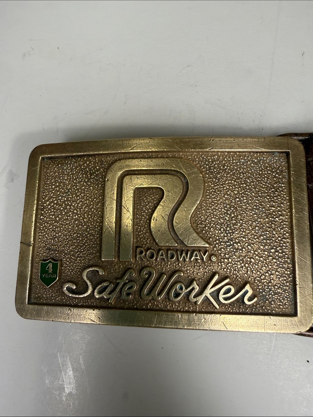 vintage brass-tone Roadway Express "Safe Worker" 4-Year belt buckle, given as an
